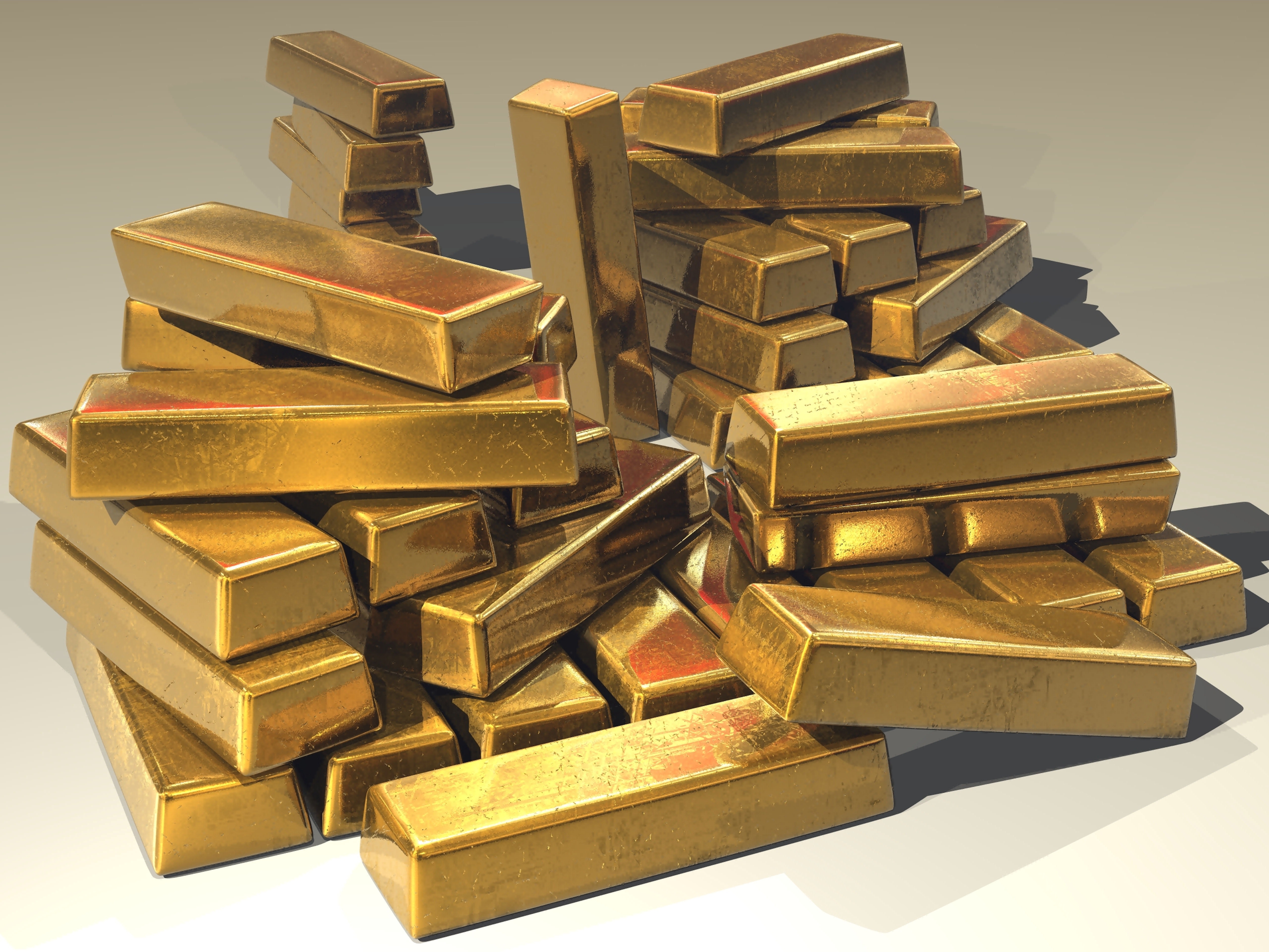 A large pile of shiny gold bars stacked together