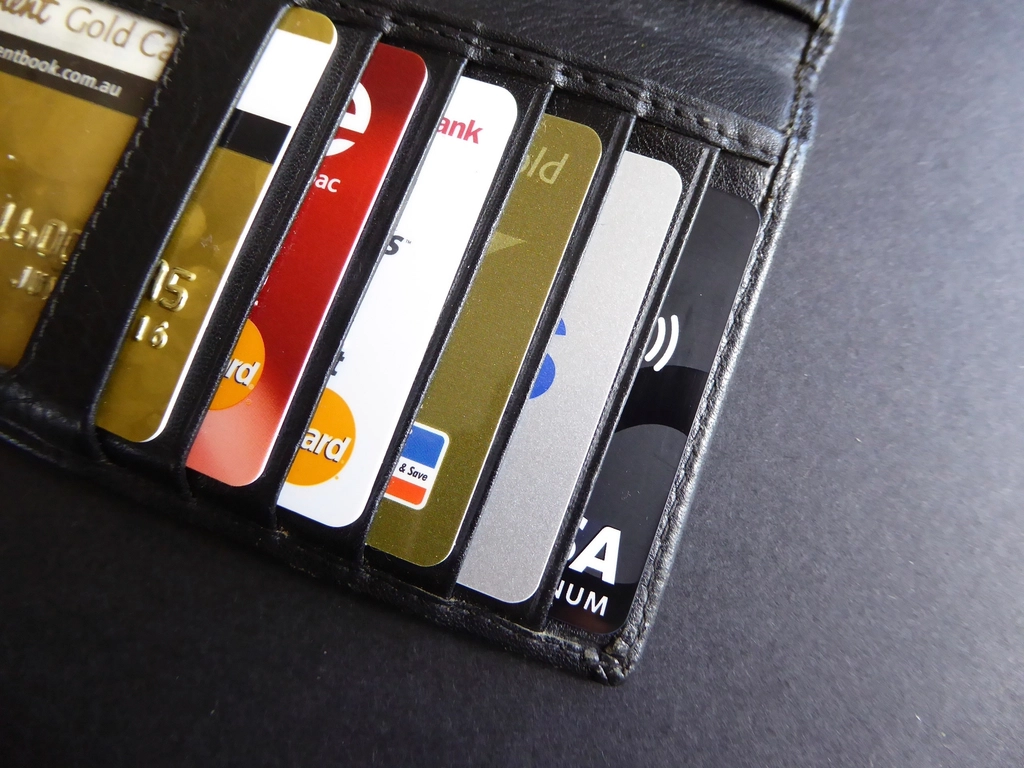 A leather wallet stuffed full of credit cards